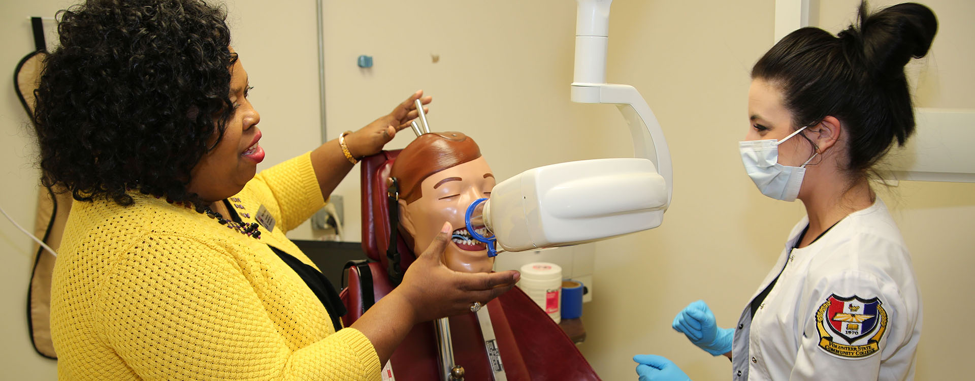 dental assisting student learning from teacher
