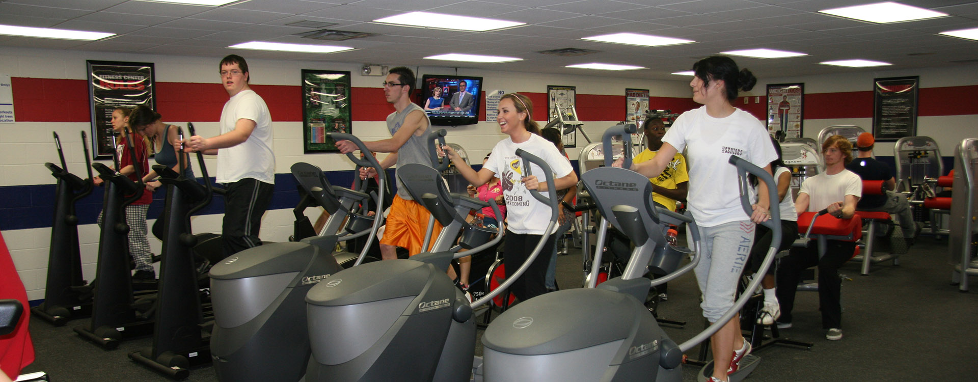 students running on treadmills in the fitness room