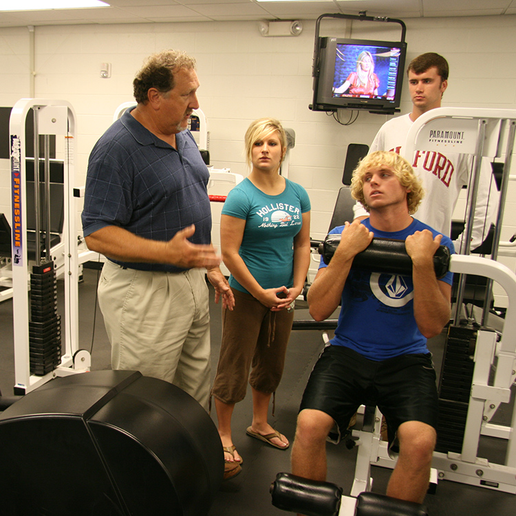 teacher instructing students in the fitness room