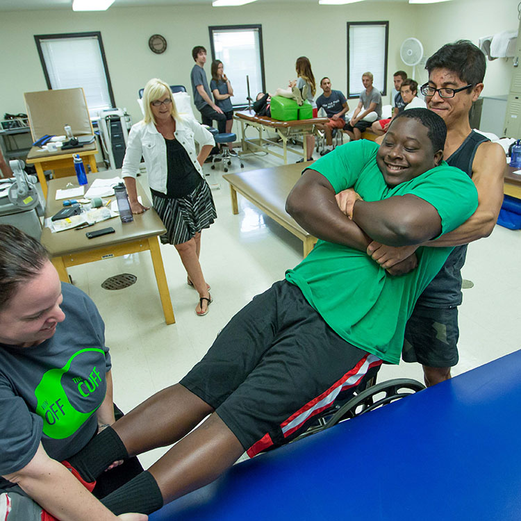 students practicing moving a patient