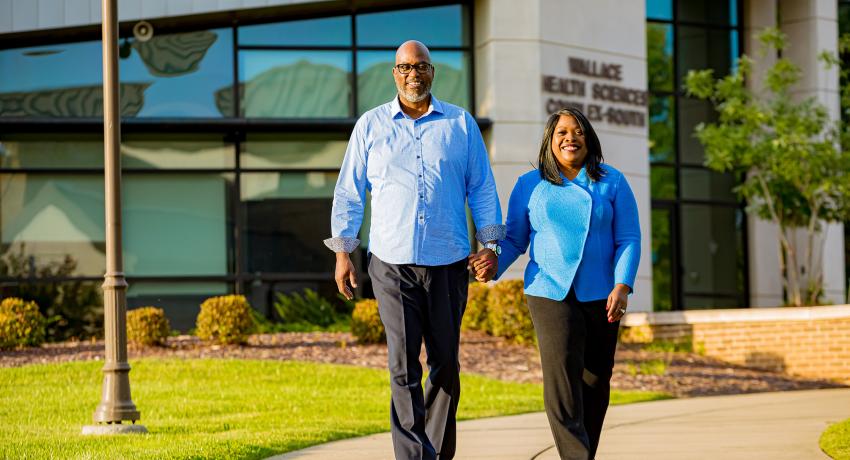 Dr. O walks with her husband on the Gallatin Campus