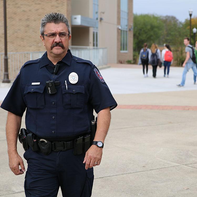 police officer walking on campus