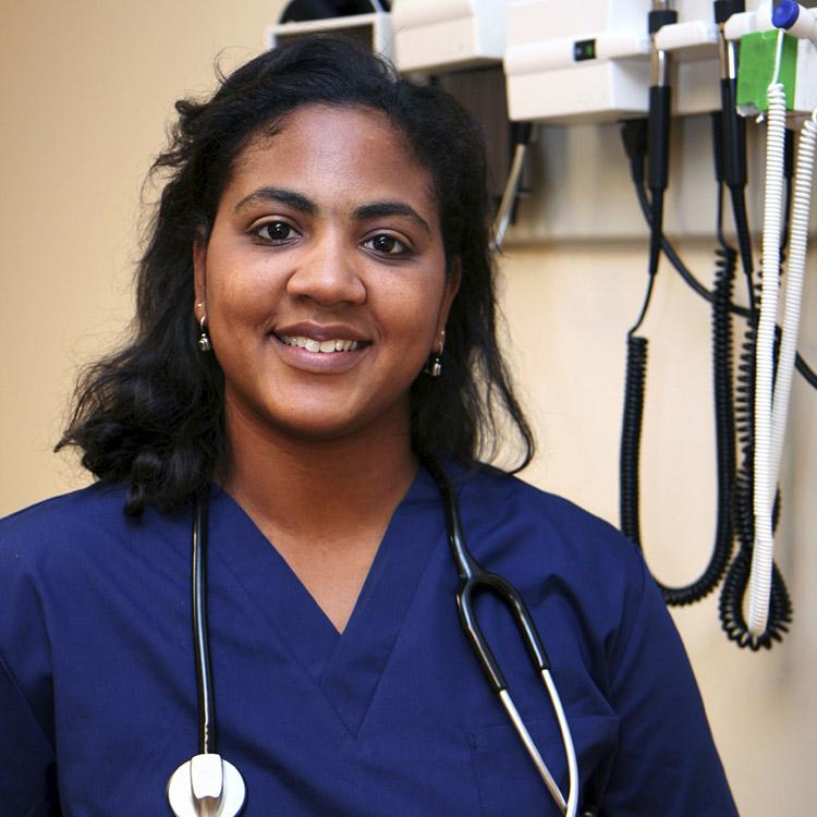 nurse wearing scrubs and smiling